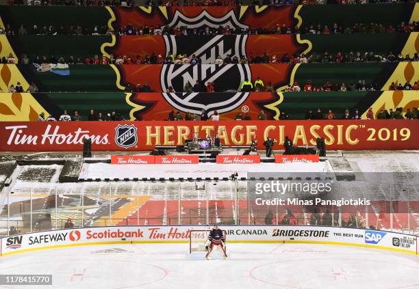 Connor Hellebuyck follows the play in the third period against the Calgary Flames during the 2019 Tim Hortons NHL Heritage Classic at Mosaic Stadium...