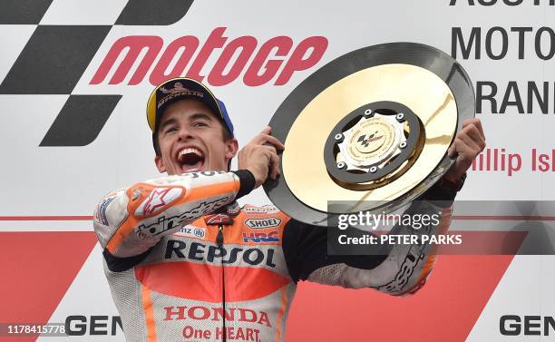 Repsol Honda MotoGP rider Marc Marquez of Spain holds up the trophy after winning the Australian motorcycle Grand Prix at Phillip Island on October...