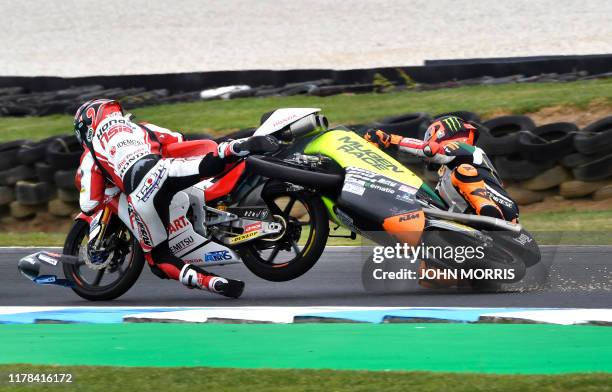 Mugen Race rider Andrea Migno of Italy crashes into Honda Team Asia rider Kaito Toba of Japan during the Moto3 Australian Grand Prix motorcycle race...