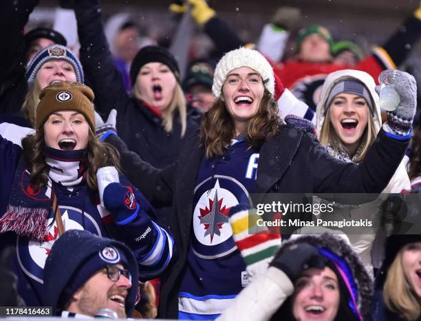 Fans cheer as the Calgary Flames take on the Winnipeg Jets during the 2019 Tim Hortons NHL Heritage Classic at Mosaic Stadium on October 26, 2019 in...