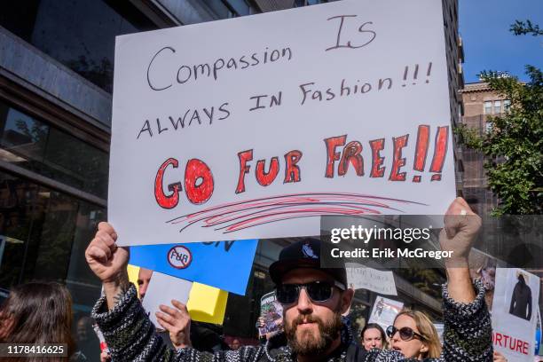 Animal rights activists holding signs while marching through the streets of New York. Hundreds of Animal Liberation activists targeted the fur trade...