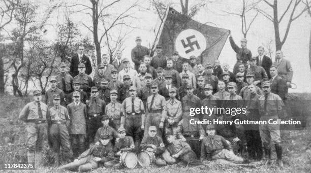 Uniformed officers of Gruppe Spandau, SA stormtroopers , as they pose for a group portrait beneath a swastika flag, in Spandau, a borough of Berlin,...