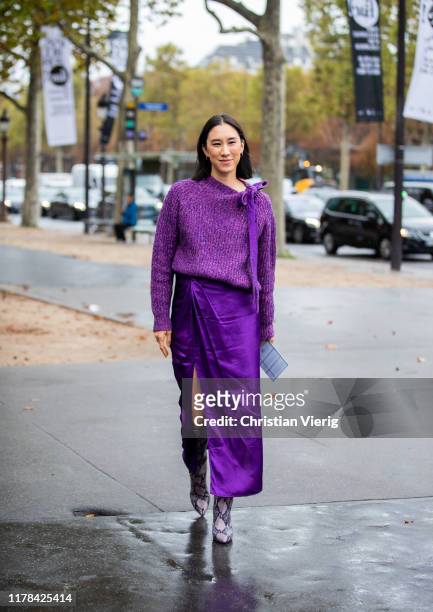Eva Chen seen wearing purple knit, silk skirt with slit, boots with snake print outside Chanel during Paris Fashion Week Womenswear Spring Summer...