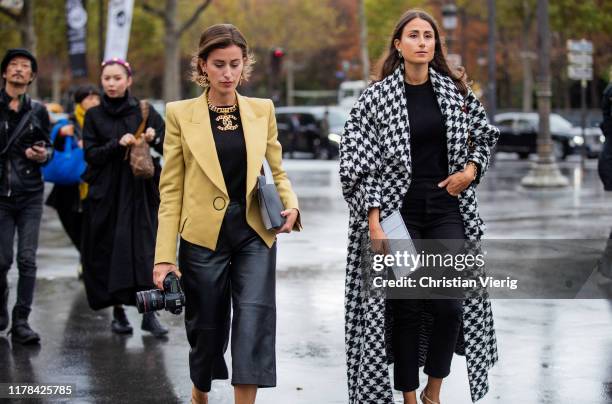 Sylvia Haghjoo wearing mustard blazer, black cropped leather pants and Julia Haghjoo wearing black white checkered coat seen outside Chanel during...