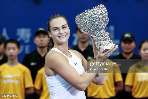 Aryna Sabalenka of Belarus holds the trophy after winning her women's singles final match against Kiki Bertens of the Netherlands in the Zhuhai Elite...