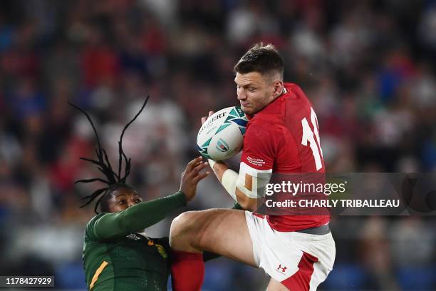 Wales' fly-half Dan Biggar catches the ball past South Africa's wing S'Busiso Nkosi during the Japan 2019 Rugby World Cup semi-final match between...