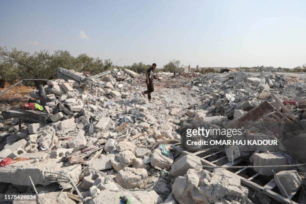 Syrian man inspects the site of helicopter gunfire which reportedly killed nine people near the northwestern Syrian village of Barisha in the Idlib...