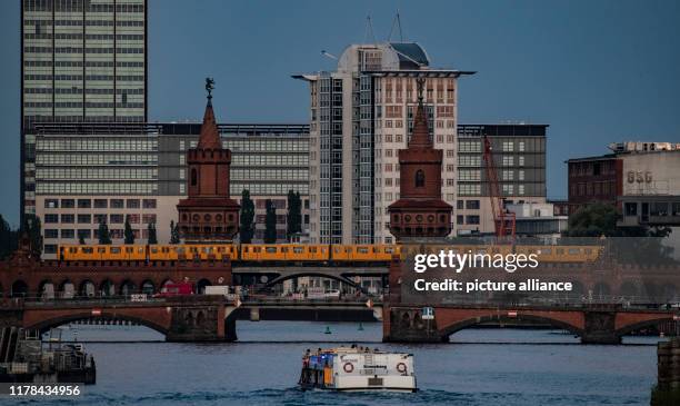 The underground U1 travels in front of the building complex "Treptowers" over the Oberbaumbrücke over the Spree. The bridge connects the two...