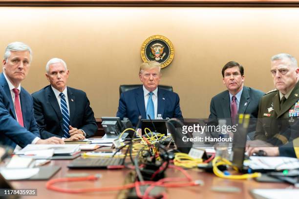 In this handout photo provided by the White House, President Donald J. Trump is joined by Vice President Mike Pence , National Security Advisor...