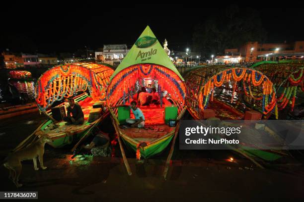 Indian boatmen wait for customers in their boats at Ram Ghat on the banks of Mandakini river on ocassion of Diwali festival,at Chitrakoot,about 128...