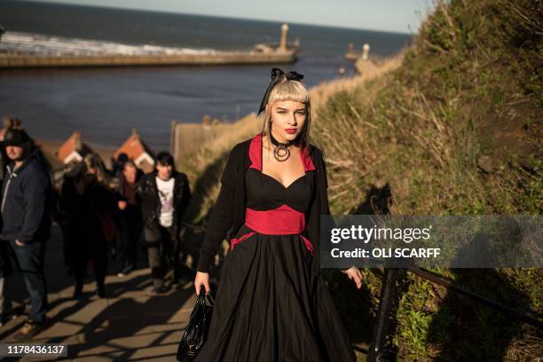 Participants in costume climb the steps to the Abbey during the biannual 'Whitby Goth Weekend' festival in Whitby, northern England, on October 27,...