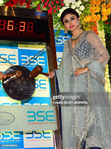 Bollywood actress Mouni Roy rings the bell to start the Muhurat Trading, a special trading session on the occasion of Diwali, the Festival of Lights,...