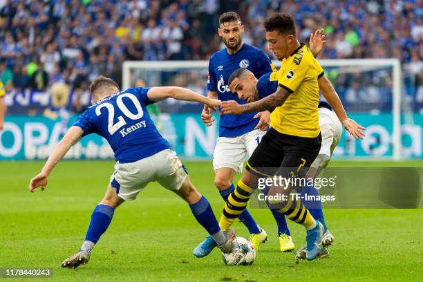 Jonjoe Kenny of FC Schalke 04, Omar Mascarell of FC Schalke 04 and Jadon Sancho of Borussia Dortmund battle for the ball during the Bundesliga match...