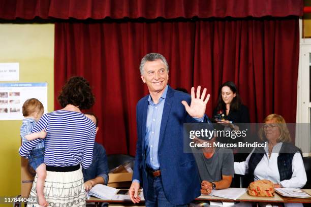 President of Argentina and Presidential candidate Mauricio Macri of 'Juntos por el Cambio' waves to the media as he casts his vote during the...