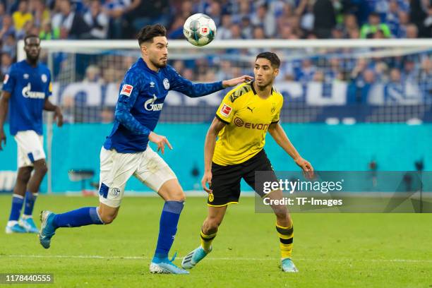 Suat Serdar of FC Schalke 04 and Achraf Hakimi of Borussia Dortmund battle for the ball during the Bundesliga match between FC Schalke 04 and...
