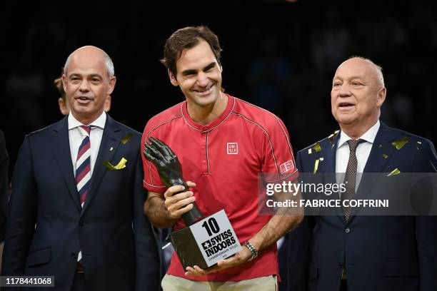 Swiss Roger Federer celebrates with his trophy after his 10th victory at the Swiss Indoors tennis tournament in Basel on October 27, 2019.