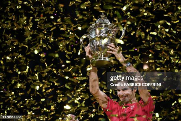 Swiss Roger Federer raises the trophy after his 10th victory at the Swiss Indoors tennis tournament in Basel on October 27, 2019.