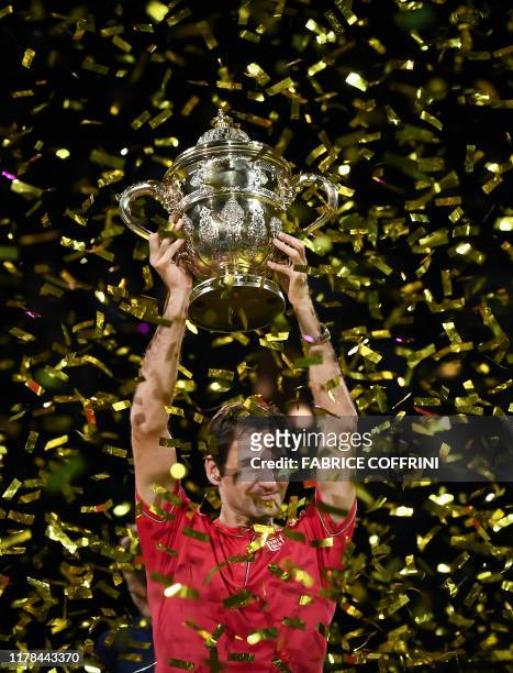 Swiss Roger Federer raises the trophy after his victory during the final match at the Swiss Indoors tennis tournament in Basel on October 27, 2019.