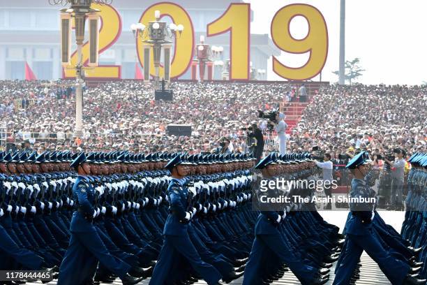 Chinese soldiers march on during the military parade to celebrate the 70th Anniversary of the founding of the People's Republic of China in 1949, at...
