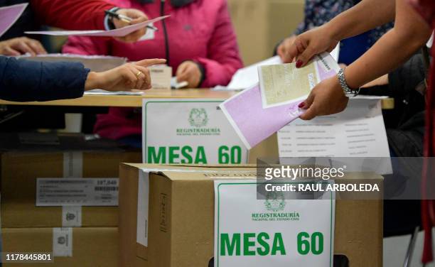Woman casts her vote at a polling station during regional elections in Bogota, Colombia on October 27, 2019. - Colombians choose their local...
