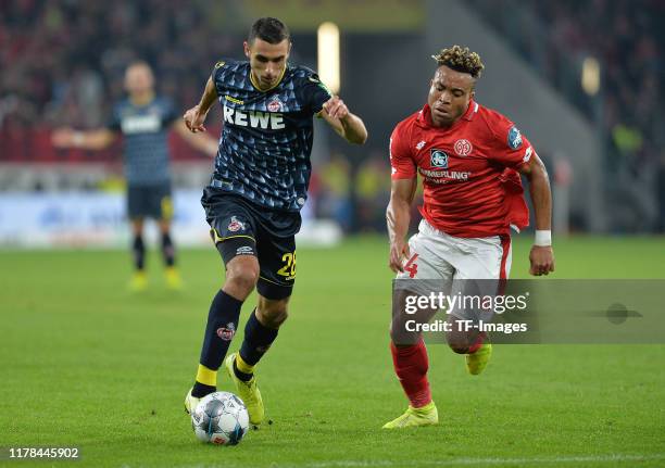 Ellyes Skhiri of 1. FC Koeln and Pierre Kunde Malong of 1. FSV Mainz 05 battle for the ball during the Bundesliga match between 1. FSV Mainz 05 and...