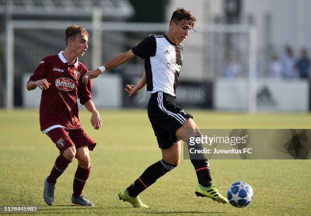 Filippo Romano Nobile of Juventus U16 evades challenge from Ludovico Ruscello of Torino U16 during the match between Juventus U16 and Torino U16 at...