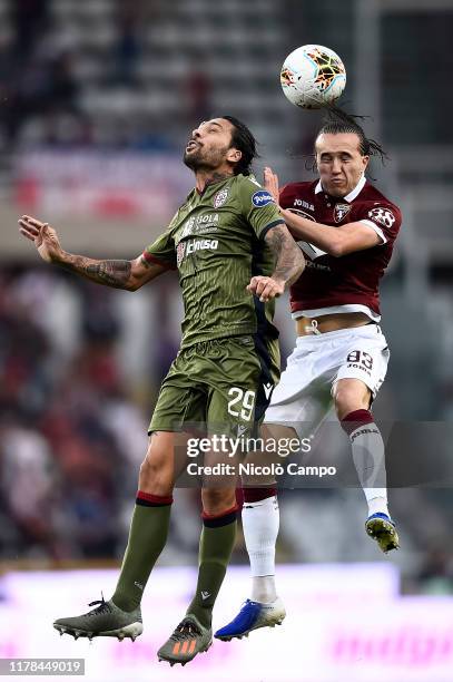 Diego Laxalt of Torino FC competes for a header with Lucas Castro of Cagliari Calcio during the Serie A football match between Torino FC and Cagliari...