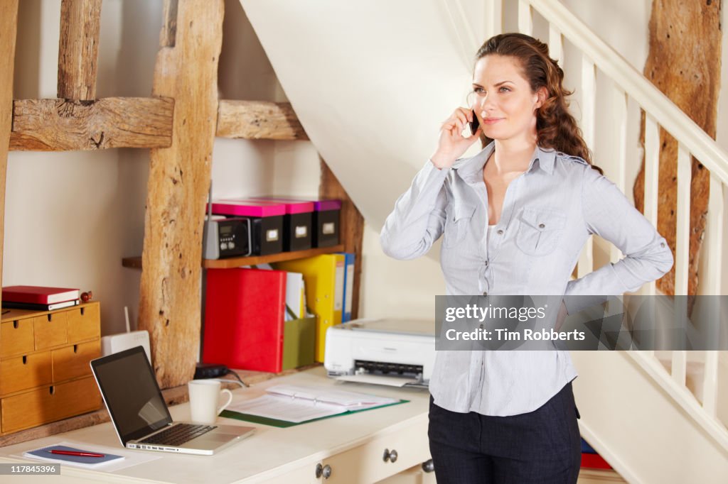 Using Phones In House Woman Using Mobile Phone At Home High-Res Stock Photo - Getty Images