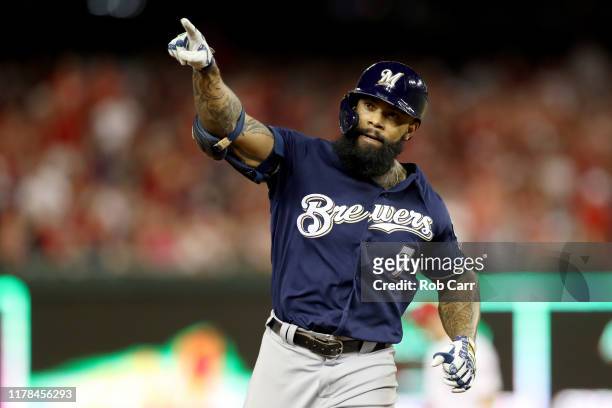 Eric Thames of the Milwaukee Brewers celebrates after scoring a home run against Max Scherzer of the Washington Nationals during the second inning in...