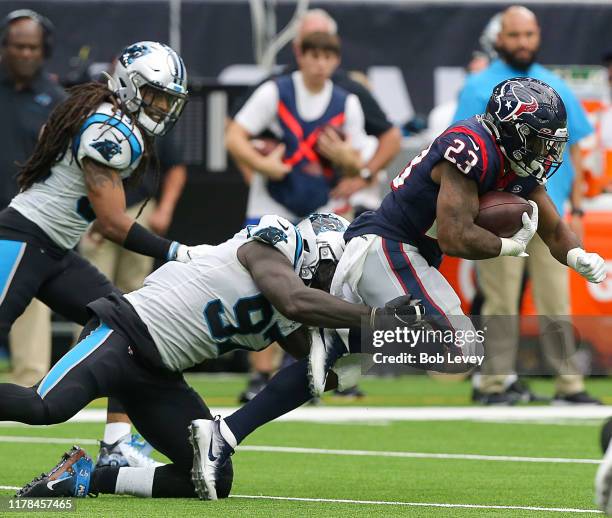 Carlos Hyde of the Houston Texans is tackled by Mario Addison of the Carolina Panthers at NRG Stadium on September 29, 2019 in Houston, Texas.