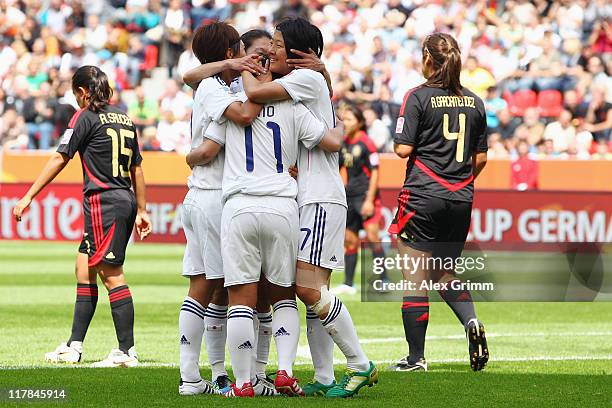 Shinobu Ohno of Japan celebrates her team's second goal with team mates during the FIFA Women's World Cup 2011 Group B match between Japan and Mexico...