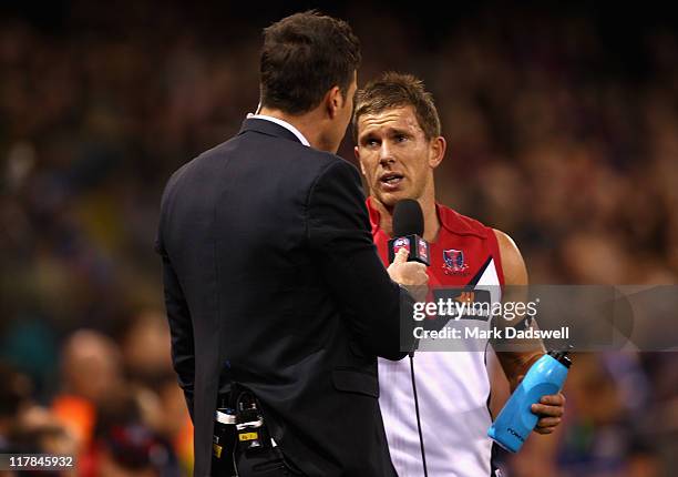 Brent Moloney of the Demons is interviewed by Matthew Richardson of the Seven Network during the round 15 AFL match between the Western Bulldogs and...