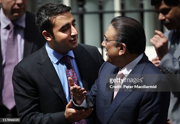 Bilawal Bhutto tries to persuade his father President Zardari of Pakistan to talk to reporters in Downing Street on July 1, 2011 in London, England....