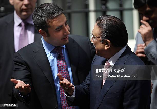 Bilawal Bhutto tries to persuade his father President Zardari of Pakistan to talk to reporters in Downing Street on July 1, 2011 in London, England....