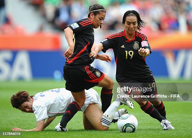 Veronica Perez and Monica Ocampo of Mexico battle with Yukari Kinga of Japan during the FIFA Women's World Cup 2011 Group B match between Japan and...