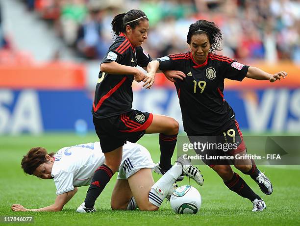 Veronica Perez and Monica Ocampo of Mexico battle with Yukari Kinga of Japan during the FIFA Women's World Cup 2011 Group B match between Japan and...