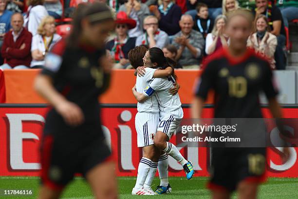 Homare Sawa of Japan celebrates her team's third goal with team mate Aya Miyama during the FIFA Women's World Cup 2011 Group B match between Japan...