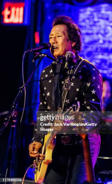American Alt-Country and -Rock musician Alejandro Escovedo plays guitar with his band at the Iridium nightclub, New York, New York, August 27, 2019.