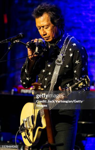 American Alt-Country and -Rock musician Alejandro Escovedo plays guitar with his band at the Iridium nightclub, New York, New York, August 27, 2019.