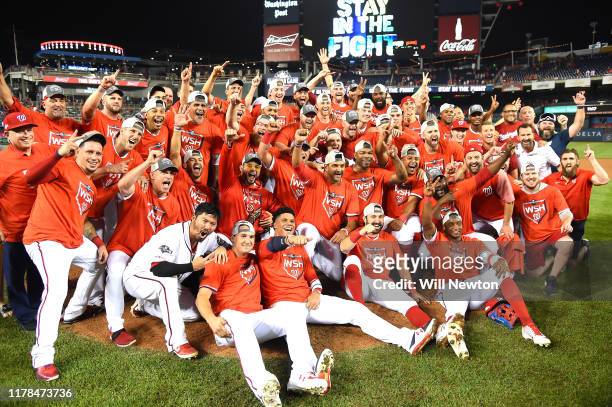 The Washington Nationals celebrate after defeating the Milwaukee Brewers with a score 4 to 3 in the National League Wild Card game at Nationals Park...