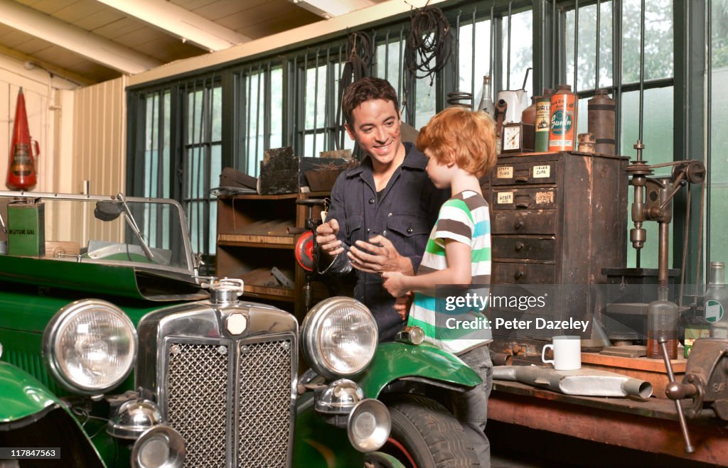 Father and son with classic car