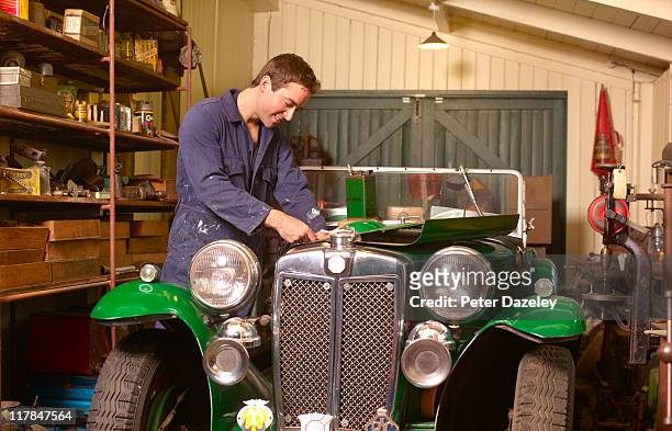 mechanic working on classic car - classic car restoration stockfoto's en -beelden