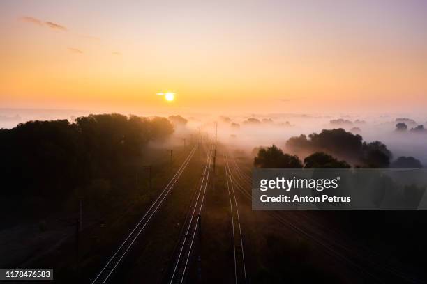 railway track at sunrise in the fog. view from the drone. - railroad track stock pictures, royalty-free photos & images