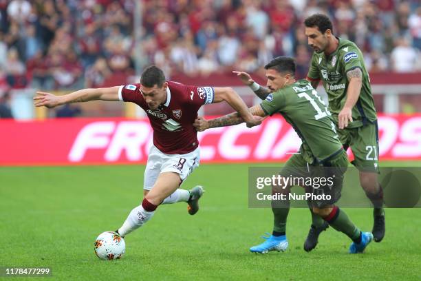 Andrea Belotti of Torino FC and Fabio Pisacane of Cagliari Calcio compete for the ball during the Serie A football match between Torino FC and...