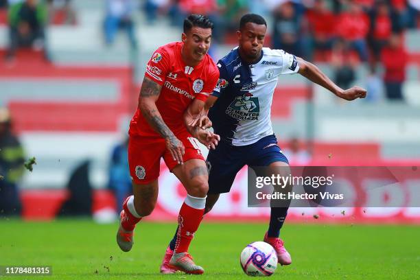 Jonathan Copete of Pachuca struggles for the ball with Diego Rigonato of Toluca during the 15th round match between Toluca and Pachuca as part of the...