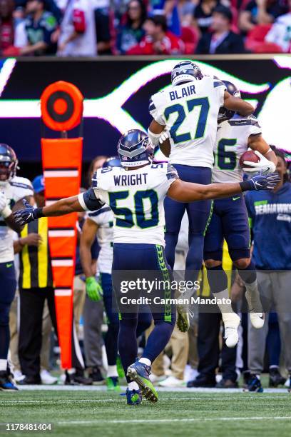 Marquise Blair, and K.J. Wright celebrate the interception by Mychal Kendricks of the Seattle Seahawks during the second quarter of a game at...