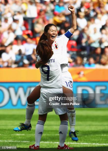 Homare Sawa of Japan celebrates with her team mate Nahomi Kawasumi after scoring her team's fourth goal during the FIFA Women's World Cup 2011 Group...