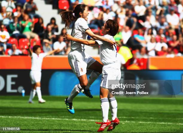 Homare Sawa of Japan celebrates with her team mate Nahomi Kawasumi after scoring her team's fourth goal during the FIFA Women's World Cup 2011 Group...