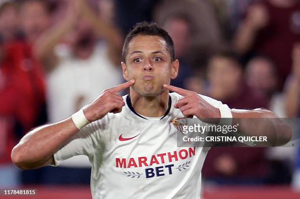 Sevilla's Mexican forward Chicharito celebrates after scoring a goal during the Spanish league football match between Sevilla FC and Getafe CF at the...