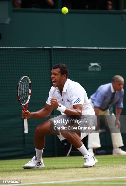 Jo-Wilfried Tsonga of France reacts to a play during his semifinal round match against Novak Djokovic of Serbia on Day Eleven of the Wimbledon Lawn...